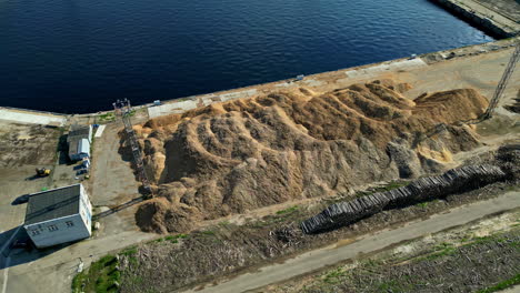 A-Mound-of-Gravel-and-Sand-in-a-Port-Area-Near-the-Harbor---Aerial-Drone-Shot