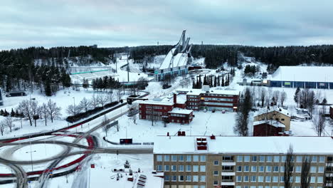 AERIAL:-in-front-of-the-Salpausselka-ski-center,-winter-day-in-Lahti,-Finland