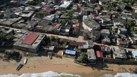 Aerial-view-of-Mohéli-or-Mwali,-part-of-the-Union-of-the-Comoros,-drone-fly-above-fisherman-village-with-car-driving-on-narrowed-road