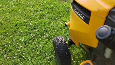 Detailed-close-up-of-a-Cub-Cadet-lawn-mower-engine-against-a-backdrop-of-freshly-cut-grass