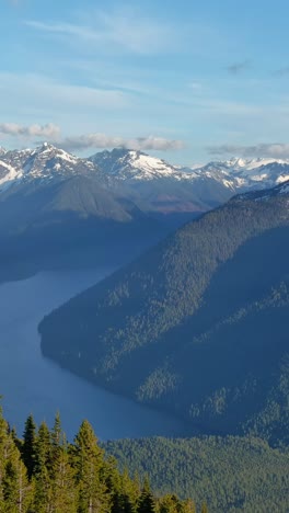 Vertical-video-of-Scenic-Lake-surrounded-by-Mountains-and-trees