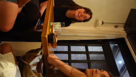 Woman-sitting-at-a-wooden-table-in-a-cozy-cafe-waiting-for-more-drinks