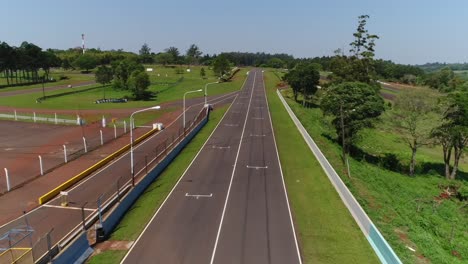 Drone-advancing-over-the-starting-line-of-the-Oberá-Racetrack-in-Misiones,-Argentina