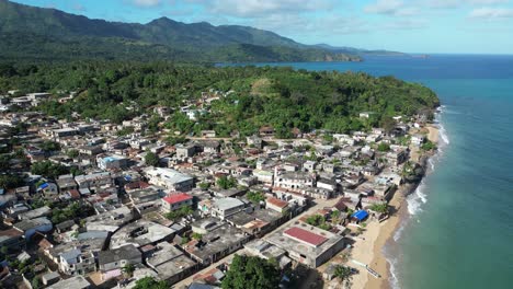 Mohéli-or-Mwali,-part-of-the-Union-of-the-Comoros,-drone-fly-above-small-town-fisherman-village-on-the-coastline-on-Indian-sea-ocean-water