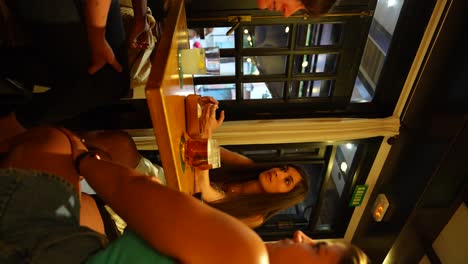 Three-women-chatting-over-drinks-in-a-cozy-indoor-cafe