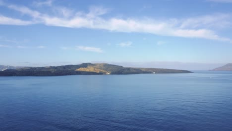 Panoramic-view-of-majestic-tranquil-blue-waters-and-green-island-inlet-with-white-buildings