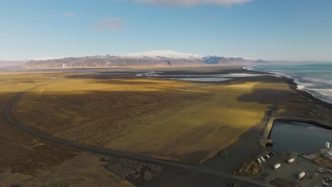 Vast-brown-green-Iceland-landscape-with-famous-volcano-Eyjafjallajökull,-aerial