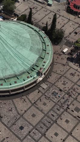 Vertical-slow-motion-aerial-shot-of-the-Basilica-of-Guadalupe's-rooftop