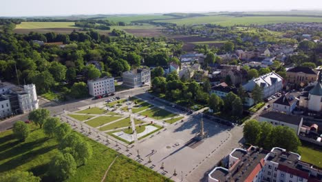 Kietrz-town-square,-surrounded-by-greenery,-residential-buildings,-and-farmland