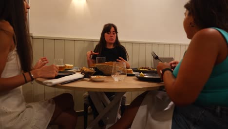 Tres-Mujeres-Cenando-Y-Conversando-En-Un-Restaurante.