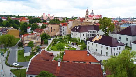 Aerial-dolly-above-grass-courtyard-lawns-and-quaint-clean-buildings-in-Vilnius,-Lithuania