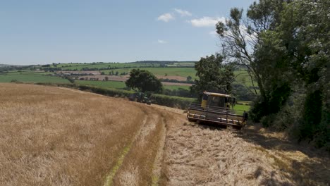 Combine-harvester-testing-its-reel-before-starting-the-harvest,-with-the-machine-positioned-at-the-edge-of-a-barley-field,-preparing-for-a-full-day-of-agricultural-work