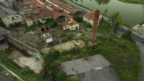 Aerial-View-Of-An-Old-Ceramic-Factory-Near-Coastal-Road-In-Italy