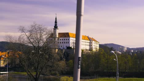 View-of-Decin-Castle-by-the-Elbe-river-valley-in-Czech-Republic,-dolly-right,-train-perspective,-green-sustainable-travel-europe