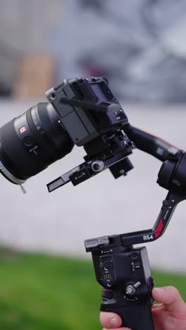 Vertical-shot-of-black-design-advanced-gimbal-stabilizer-with-camera-mounted