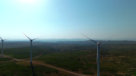 Aerial-orbiting-shot-revealing-a-row-of-wind-turbines-not-producing-energy