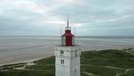 Medium-drone-shot-circling-ccounterlockwise-around-the-top-of-Blåvand-Lighthouse-with-beacon-off