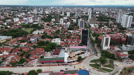 City-aerial-orbits-vehicles-in-traffic-roundabout,-Santa-Cruz-Bolivia