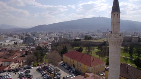 A-mosque-with-Skopje-city-and-mountains-in-the-background,-showcasing-cultural-and-natural-beauty