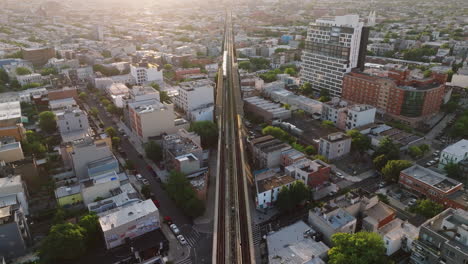 Aerial-view-of-a-subway-train-in-Brooklyn-at-sunrise