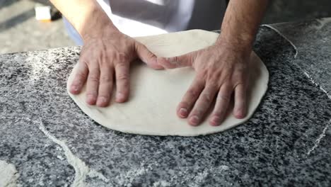 A-chief-Kneads-the-dough-to-make-Italian-pizza,-close-up-shot,-insert-shot