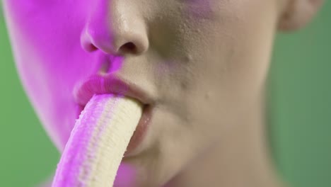 Attractive-woman-eating-a-banana,-mouth-close-up-detail