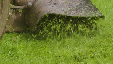 Ride-On-LawnMower-Bumping-Up-and-Down-as-Cut-Grass-is-Ejected-in-Slow-Motion-to-Mulch-and-Improve-Quality-4K