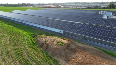 Descending-drone-shot-of-stable-and-barns-with-modern-solar-panels-on-roof