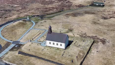 Strandarkirkja-church-with-ocean-and-island-views-and-scenic-coastline-of-Iceland's-south-coast-with-surrounding-landscape-and-atmosphere