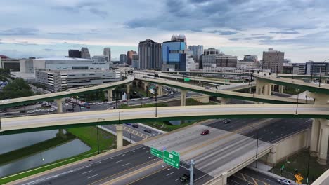 Drone-flight-over-elevated-highways-in-Orlando-City-at-sunrise