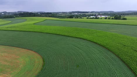 Drone-flight-over-different-farm-field-plantation-in-america-during-thunderstorm