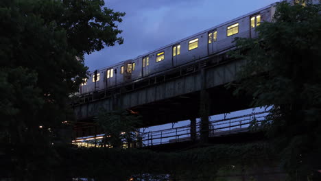 Toma-Aérea-De-Un-Tren-Subterráneo-En-Brooklyn-Por-La-Noche.