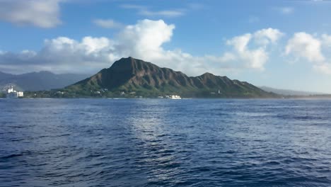 Calm-Blue-ocean-water-of-pacific-ocean-with-Diamond-head-and-waikiki-honolulu-skyline-in-the-background