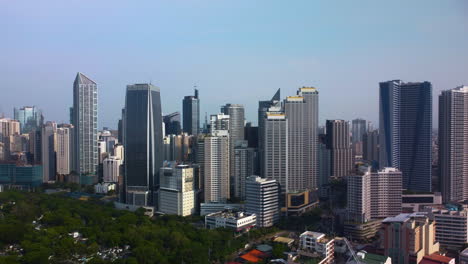 Aerial-tracking-shot-in-front-of-skyscrapers-of-Makati-city,-in-Manila,-Philippines