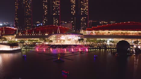 Embark-on-a-night-drone-exploration-of-Marina-Bay-with-this-captivating-aerial-footage-that-showcases-the-glowing-beauty-of-Singapore's-iconic-skyline