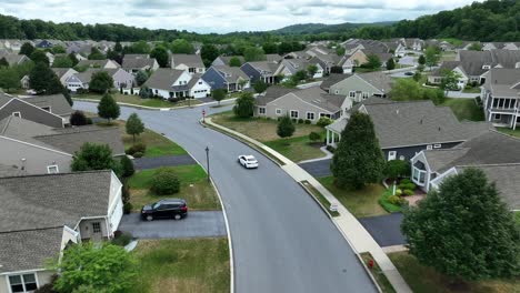 White-car-on-street-of-american-residential-area-during-cloudy-day