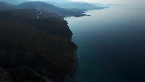 Ionian-horizon-with-mountain-coastline-silhouettes-and-a-hidden-beach-in-Gjipe,-Albania,-a-secret-paradise