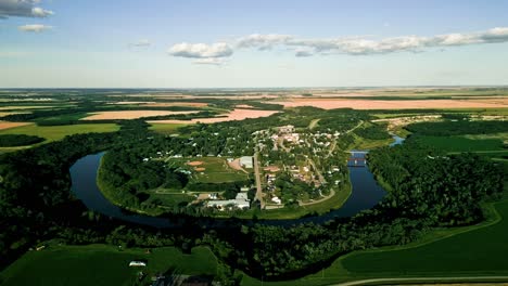 Cinematic-Drone-View-of-a-Canadian-Town-in-a-Valley-Surrounded-by-Farmland