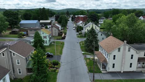 Aerial-flyover-main-street-of-old-suburb-neighborhood-during-cloudy-day