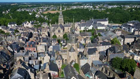 Approaching-aerial-movement-from-the-Tour-de-l'Horloge-or-Clock-Tower-and-Saint-Sauveur-basilica,-Dinan,-France