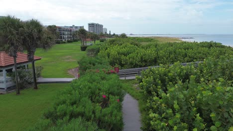 Flying-over-a-boardwalk-in-Treasure-Island-Florida-on-a-calm,-clear-morning