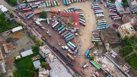 A-bustling-urban-area-with-colorful-buildings,-diverse-traffic,-and-market-stalls,-aerial-view