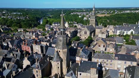 Receding-aerial-movement-from-the-Tour-de-l'Horloge-or-Clock-Tower-and-Saint-Sauveur-basilica,-Dinan,-France