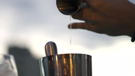 Bartender-expert-in-mixology-prepares-cocktail-at-festive-event