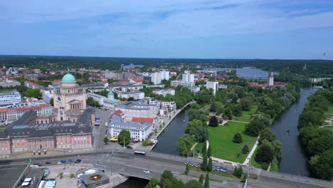 Potsdam-city-center-with-red-roofs-and-green-trees-surrounding-it-on-a-sunny-and-cloudy-day