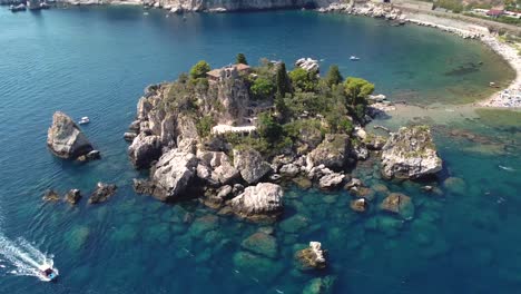 Circular-drone-shot-around-Isola-Bella-in-Taormina,-Sicily