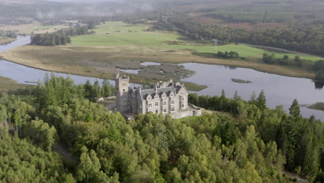 An-aerial-view-of-Carbisdale-Castle-on-a-sunny-morning-with-cloudy-skies