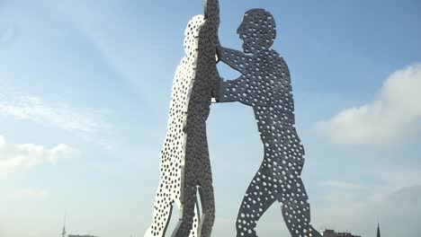 Reflection-of-famous-Molecule-Man-on-river-Spree-in-east-Berlin,-Germany