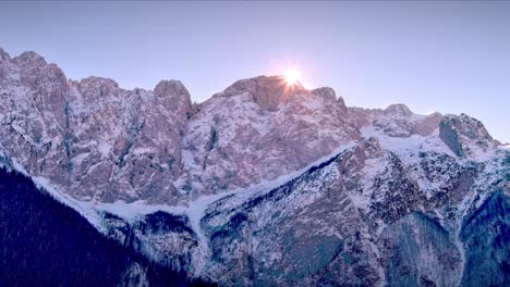 In-the-background-a-Vald-di-Scalve-mountain-rises-majestically,-its-peak-covered-in-a-thick-blanket-of-snow