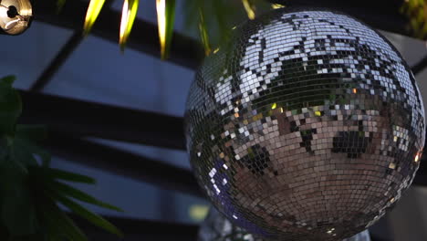 Silver-disco-ball-hangs-from-ceiling-in-dance-hall